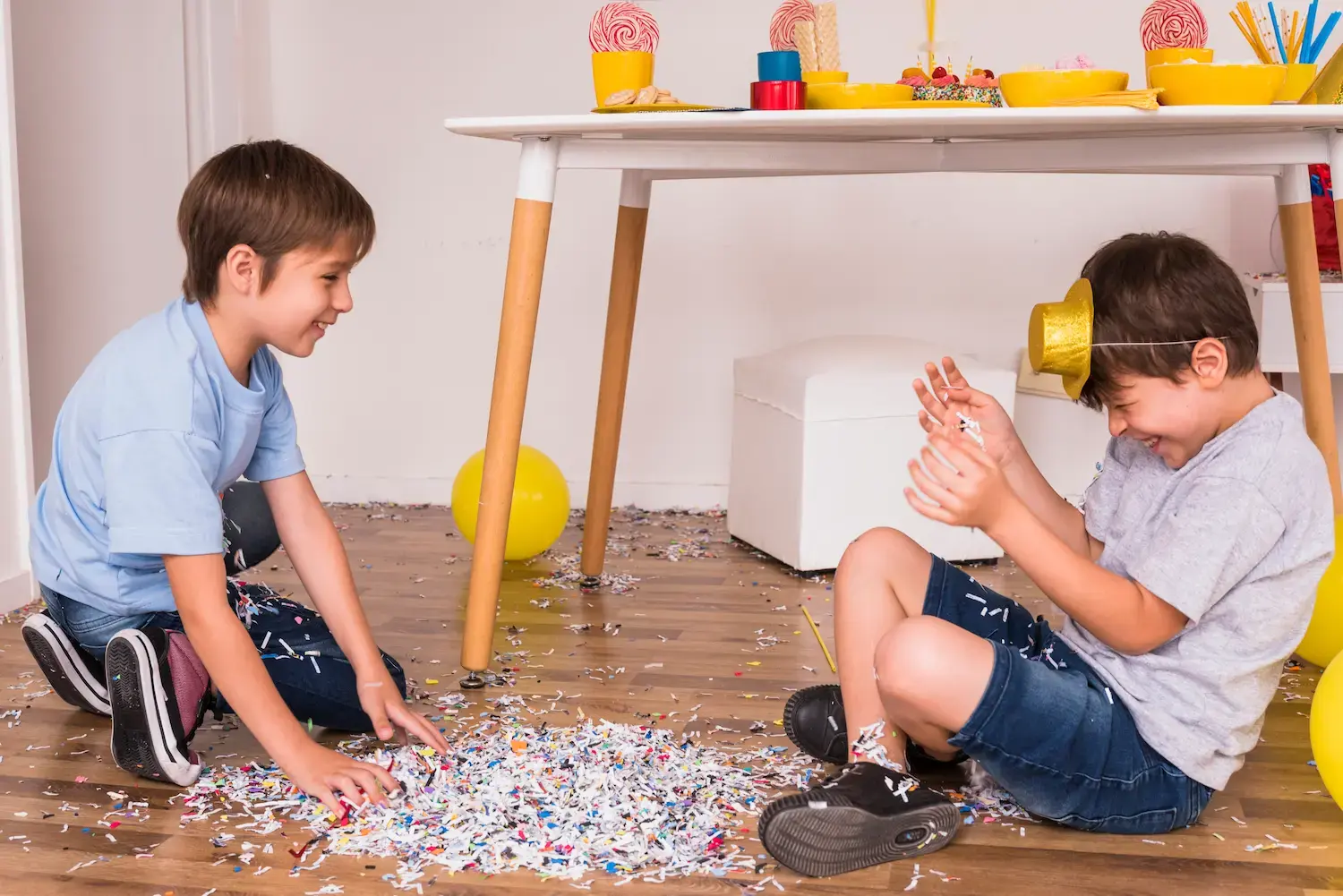 Happy kids enjoying a party with confetti