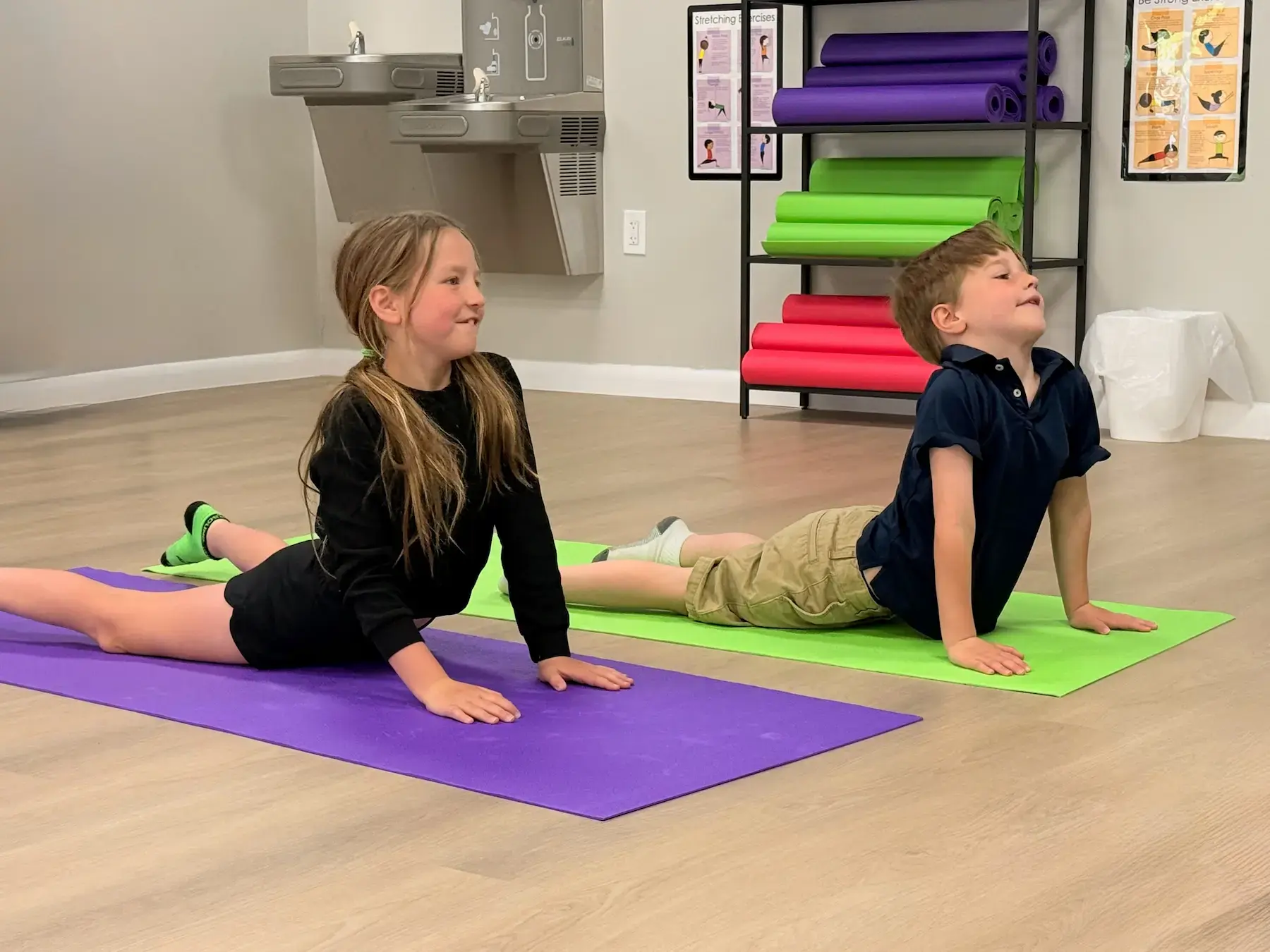 Kids practicing yoga at Cue the Party in Greensboro